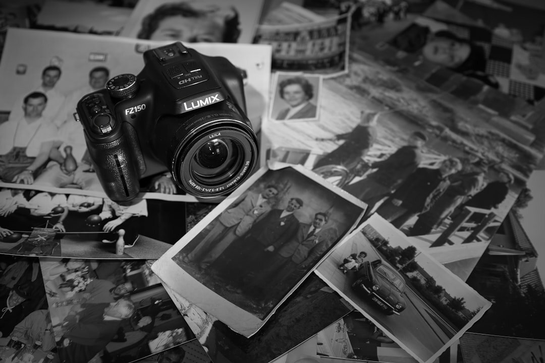 Camera equipment and printed photographs laid out for a photo edit