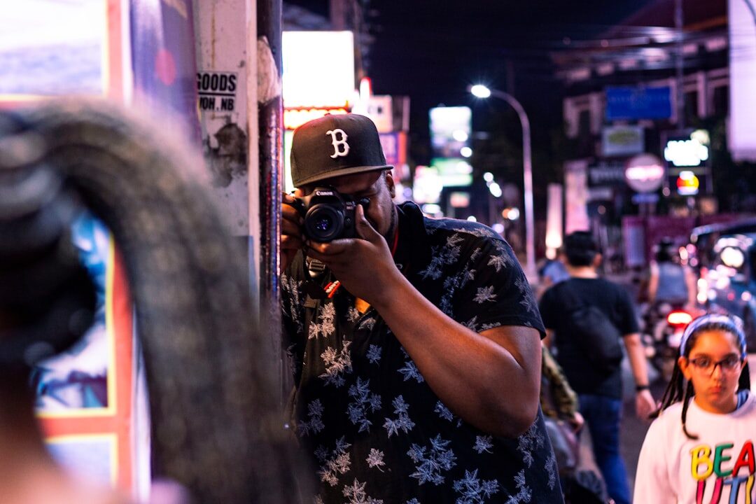 Photojournalist photographing a street scene during a reportage assignment